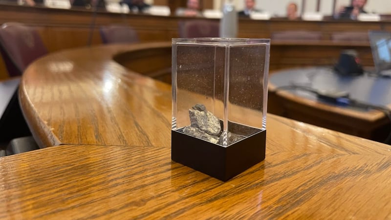 A container with 10 grams of yttrium, a rare earth element, is passed around during a meeting...